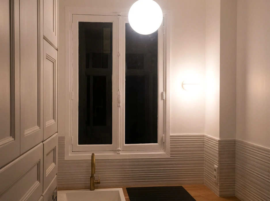 Couloir de rénovation contemporaine avec murs en pierre calcaire apparente encadrant un passage